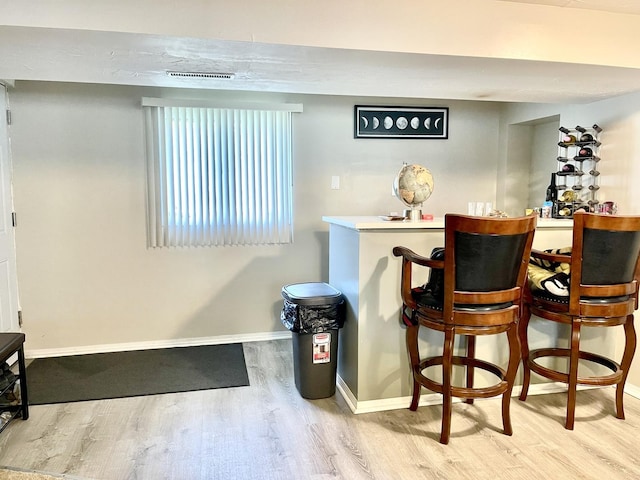 bar with hardwood / wood-style flooring