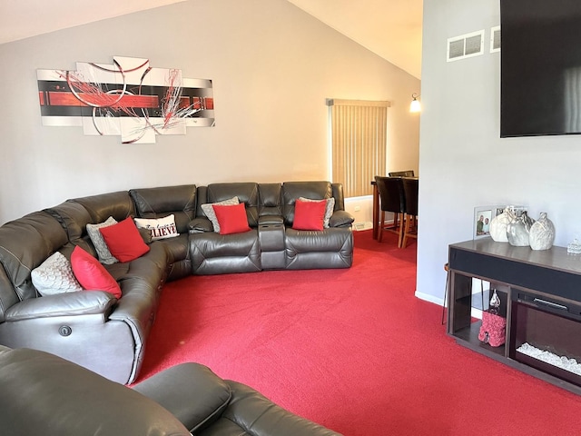 carpeted living room featuring lofted ceiling