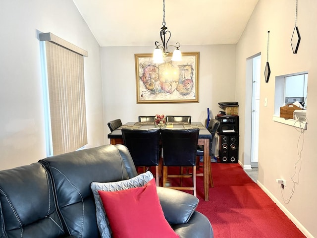 carpeted dining space featuring lofted ceiling and a chandelier