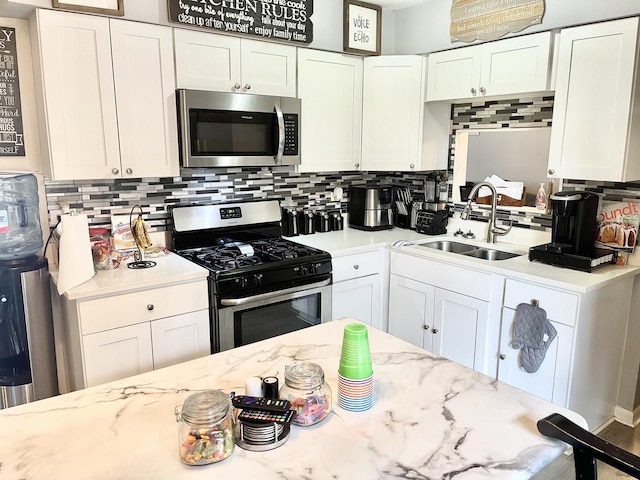 kitchen with white cabinets, stainless steel appliances, and sink