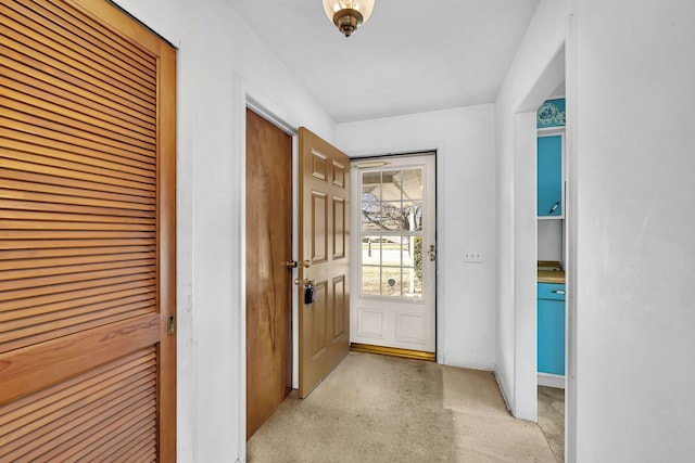 doorway featuring light carpet