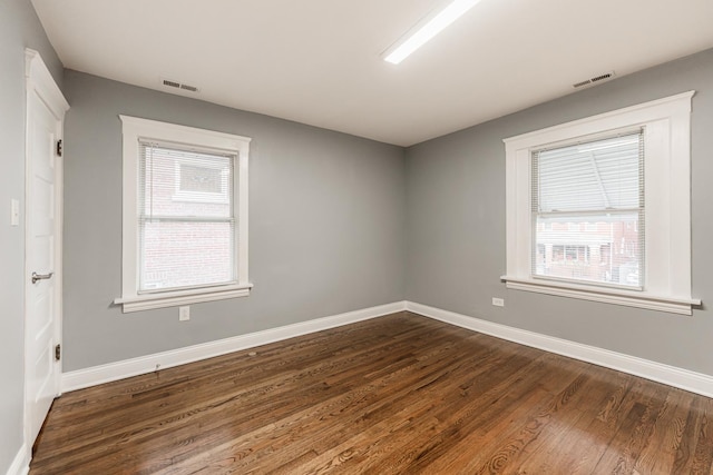 spare room with dark hardwood / wood-style flooring