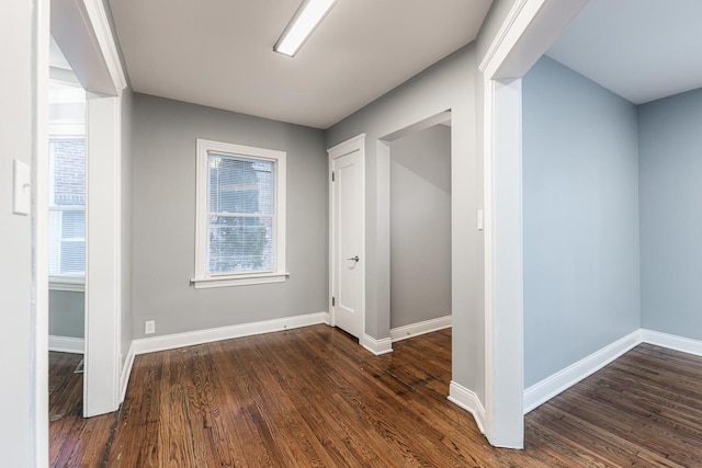 corridor with dark hardwood / wood-style flooring, beamed ceiling, and coffered ceiling