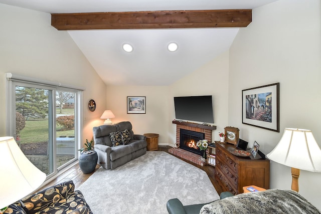 living room with hardwood / wood-style flooring, a fireplace, and lofted ceiling with beams