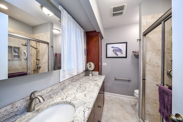 bathroom with vanity, an enclosed shower, and toilet