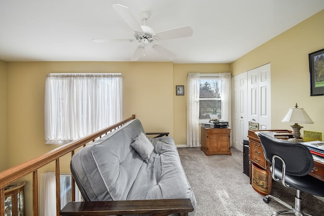 office featuring ceiling fan and light carpet