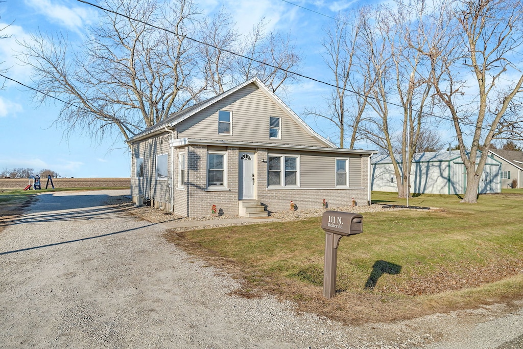 bungalow-style home featuring a front yard