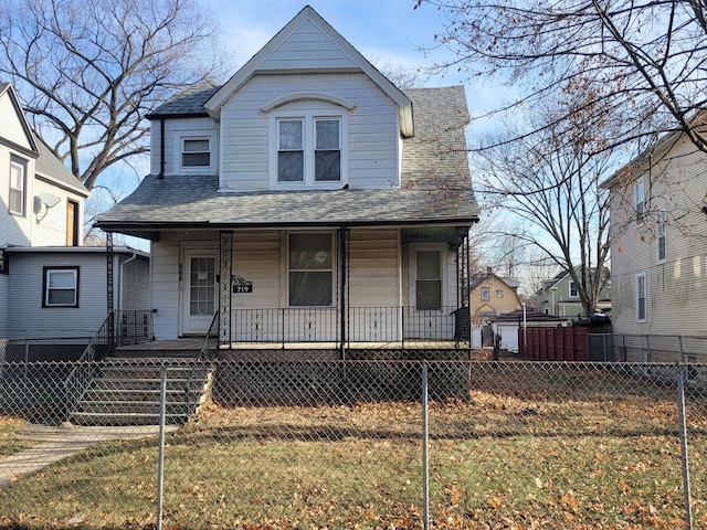 view of front facade featuring covered porch and a front yard