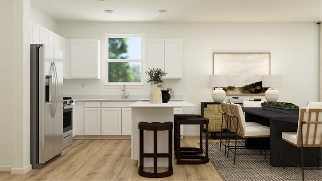 kitchen with white cabinets, stainless steel appliances, light wood-type flooring, and a sink