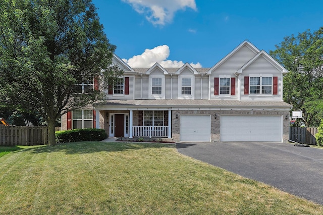 view of front facade featuring a front lawn, a garage, and covered porch