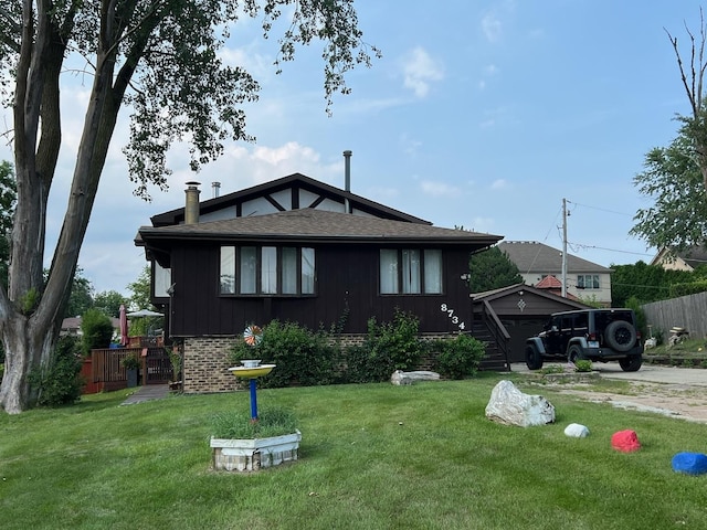 view of front of property with a front yard and a garage