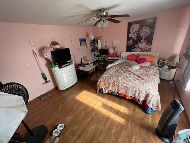 bedroom featuring ceiling fan and wood-type flooring