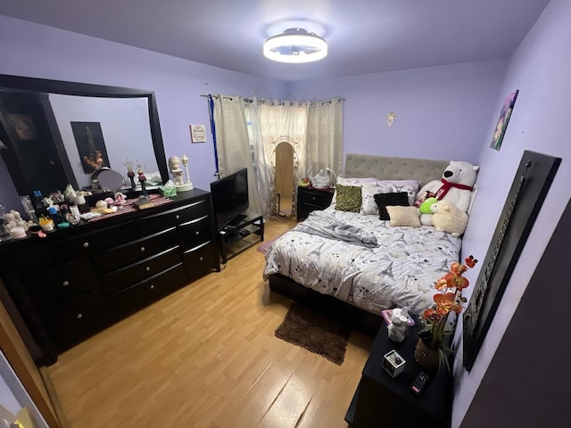 bedroom with hardwood / wood-style flooring