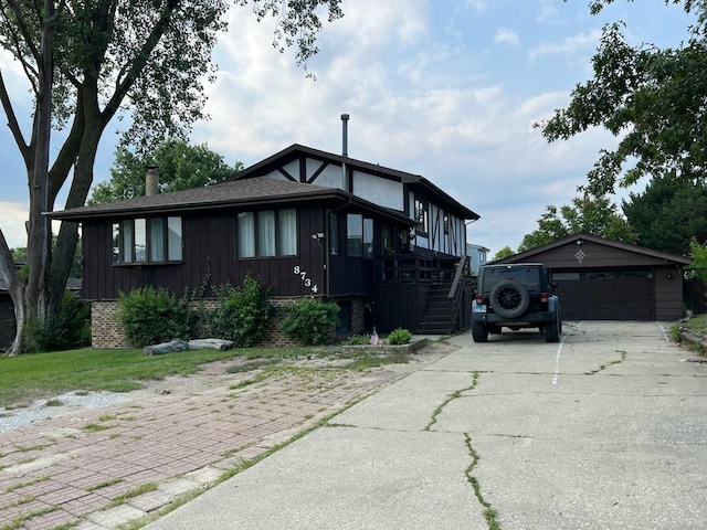 view of front facade featuring a garage and an outbuilding