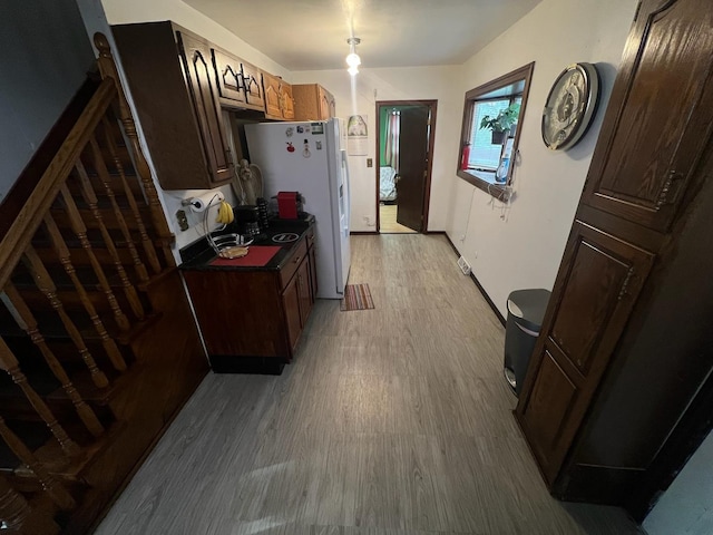 kitchen featuring white refrigerator and light wood-type flooring