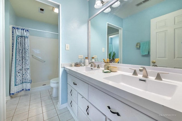 bathroom with toilet, vanity, tile patterned floors, and curtained shower