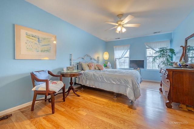 bedroom with ceiling fan and light hardwood / wood-style flooring