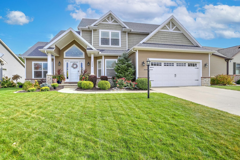 craftsman-style home featuring a front yard and a garage