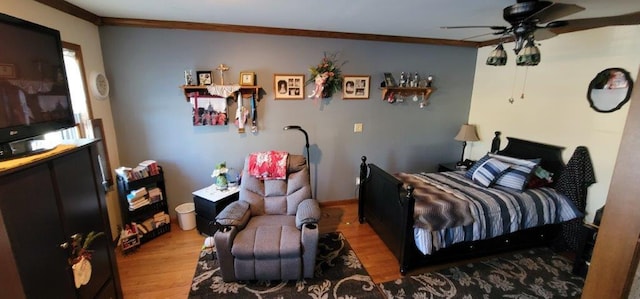 bedroom with hardwood / wood-style flooring, ceiling fan, and crown molding