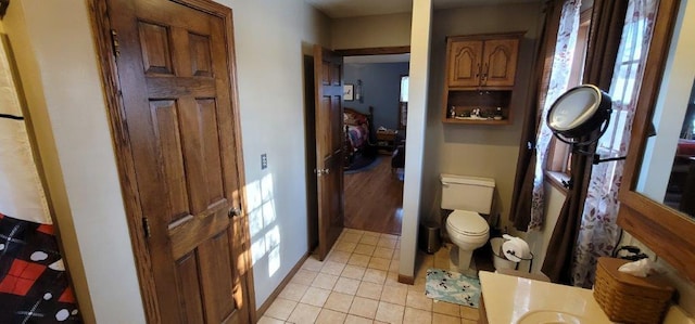 bathroom with toilet and tile patterned floors