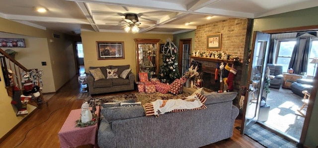 living room with beamed ceiling, ceiling fan, dark wood-type flooring, and coffered ceiling