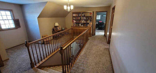 hall with carpet and a notable chandelier