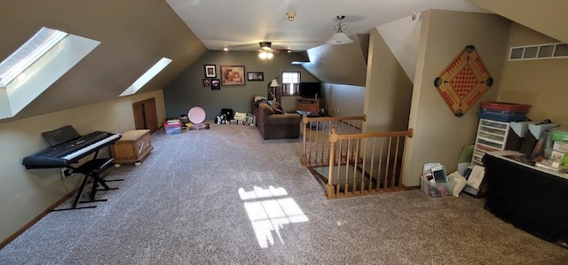 bonus room featuring light colored carpet, lofted ceiling with skylight, and ceiling fan