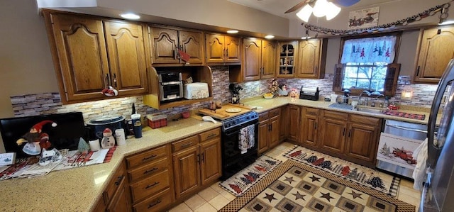 kitchen with black / electric stove, decorative backsplash, light tile patterned flooring, and ceiling fan