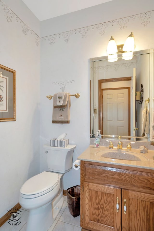 bathroom featuring tile patterned flooring, vanity, and toilet