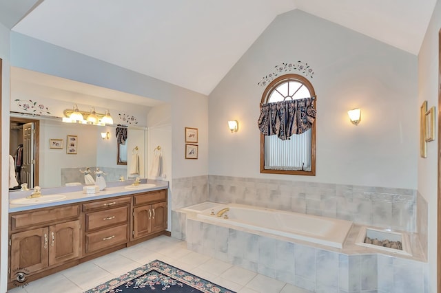 bathroom featuring tiled bath, tile patterned flooring, vanity, and lofted ceiling