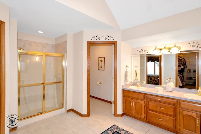 bathroom featuring vanity, tile patterned floors, a shower with door, and vaulted ceiling