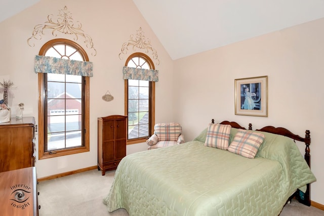 bedroom featuring light carpet and high vaulted ceiling