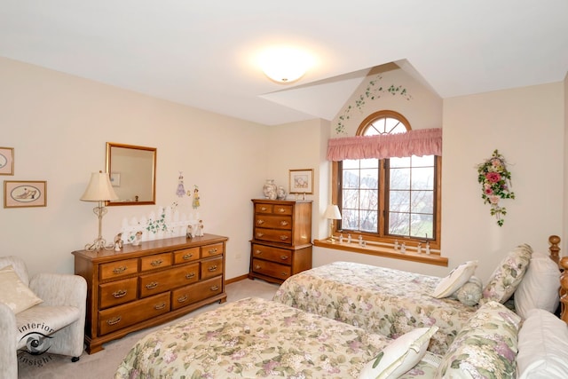 carpeted bedroom featuring lofted ceiling