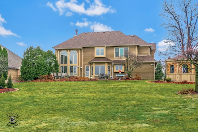 rear view of house with a lawn