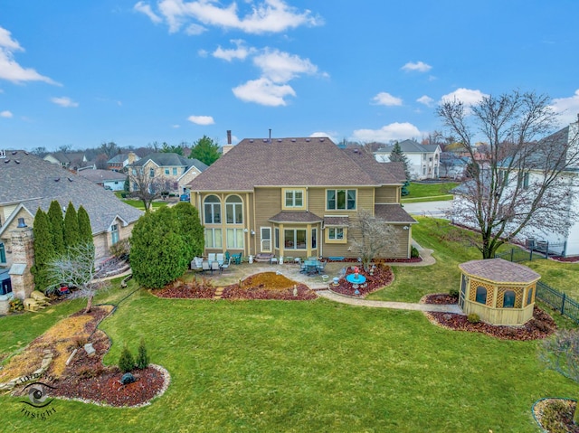 rear view of property featuring a yard and a patio