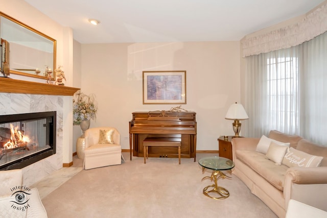 living room with light carpet and a tiled fireplace