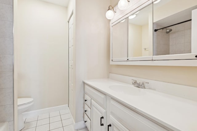 bathroom featuring tile patterned floors, vanity, toilet, and a tile shower