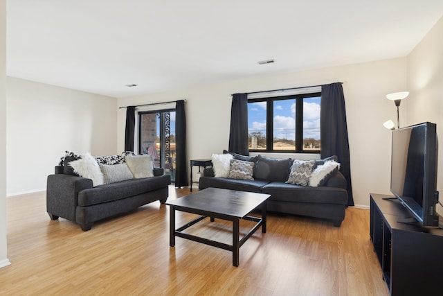 living room featuring light hardwood / wood-style flooring and plenty of natural light