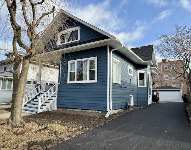 view of side of home featuring a garage and an outdoor structure