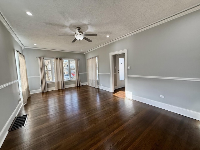 empty room featuring dark hardwood / wood-style flooring, ornamental molding, and a textured ceiling