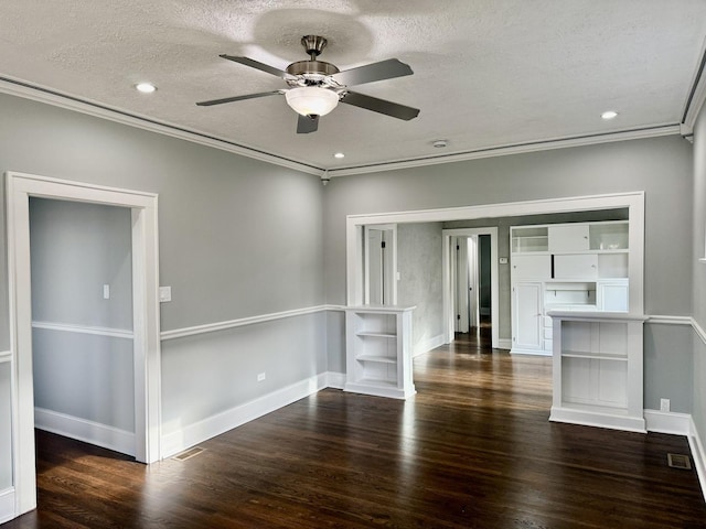 spare room featuring ceiling fan, dark hardwood / wood-style floors, a textured ceiling, and ornamental molding