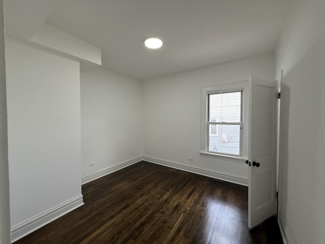 unfurnished room with dark hardwood / wood-style floors