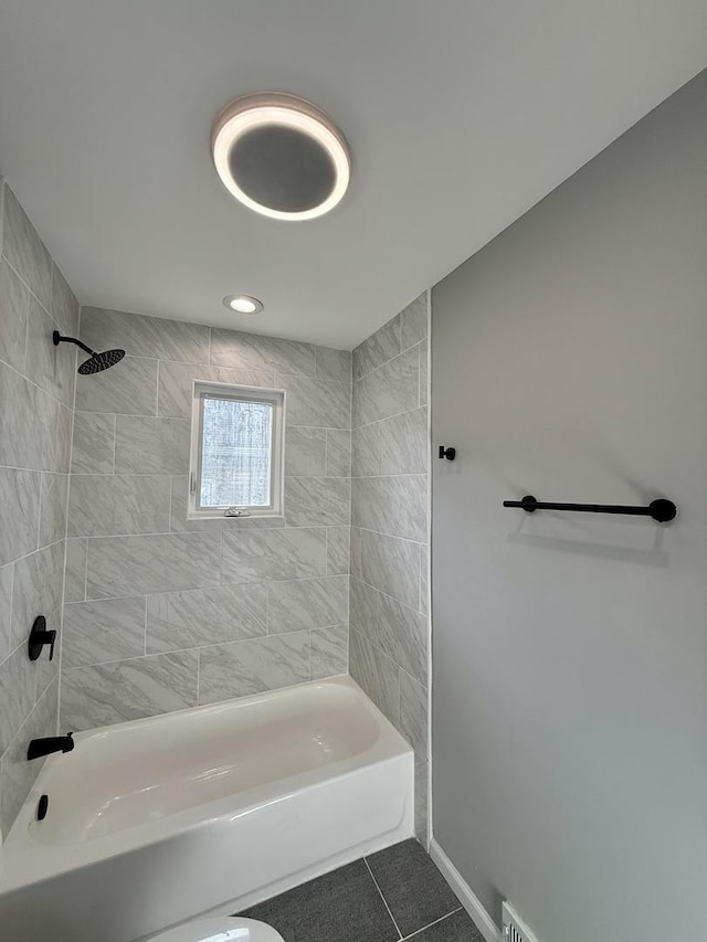 bathroom featuring tile patterned floors and tiled shower / bath