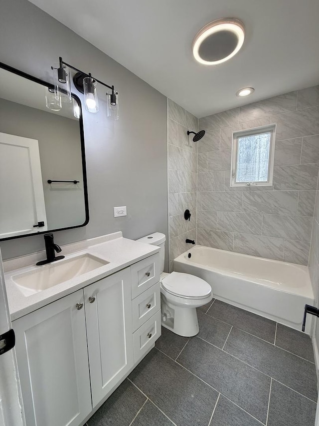 full bathroom with tile patterned flooring, vanity, toilet, and tiled shower / bath