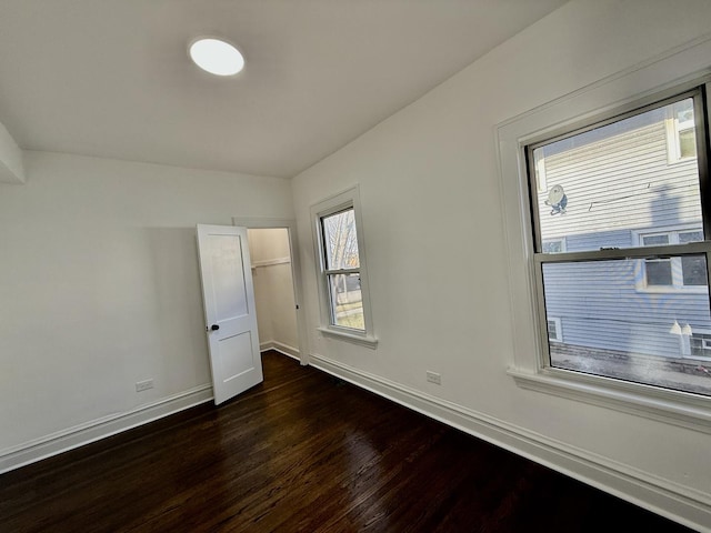 unfurnished bedroom featuring dark wood-type flooring