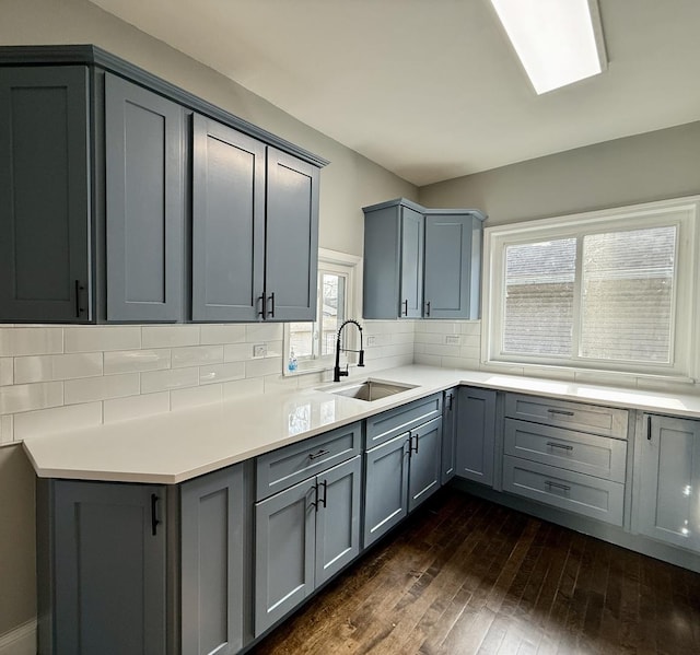 kitchen featuring gray cabinetry, plenty of natural light, dark wood-type flooring, and sink