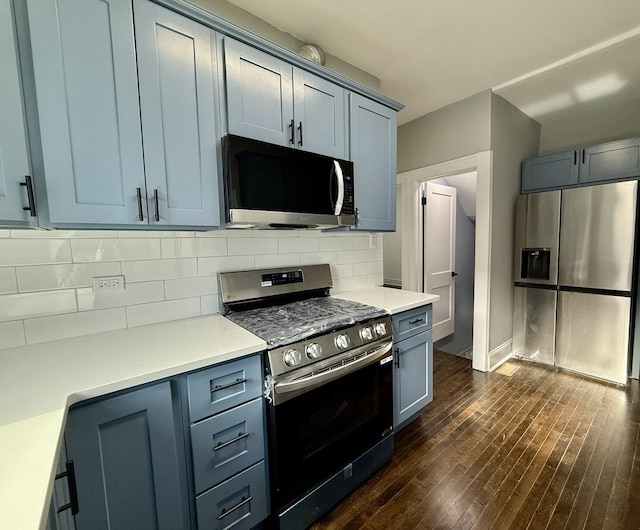 kitchen featuring backsplash, dark hardwood / wood-style flooring, and appliances with stainless steel finishes