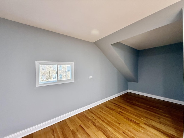 bonus room featuring hardwood / wood-style floors and vaulted ceiling