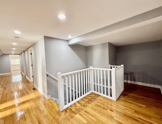 hall with hardwood / wood-style flooring