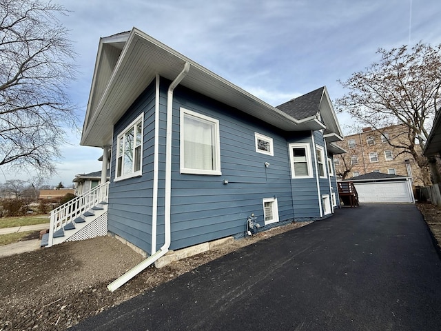 view of side of property featuring an outdoor structure and a garage